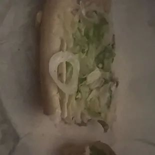 a sandwich with lettuce and onions