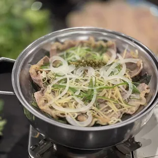 a pot of noodles and vegetables