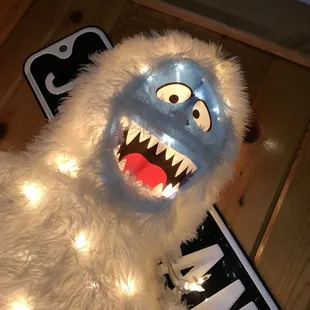 a white furry monster with a blue face