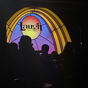 people sitting in front of a stained glass window