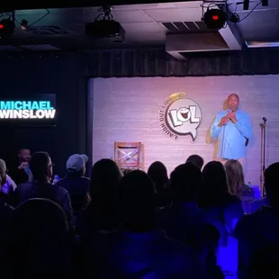 a man on a stage giving a speech