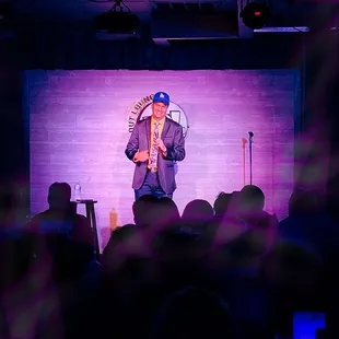 a man on stage with a microphone