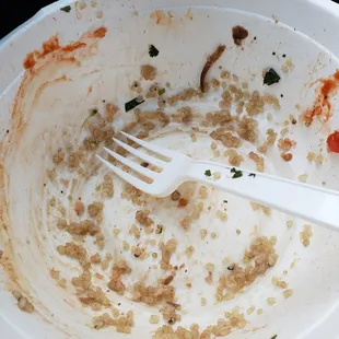 a dirty plate with a fork in it