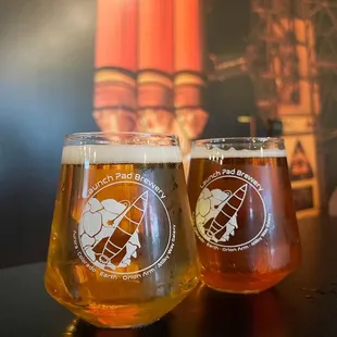 two glasses of beer on a table