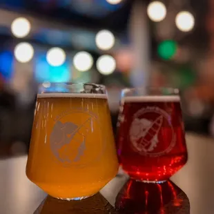 two glasses of beer on a table