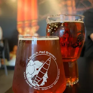 two glasses of beer on a table
