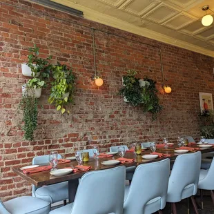 a brick wall with hanging plants
