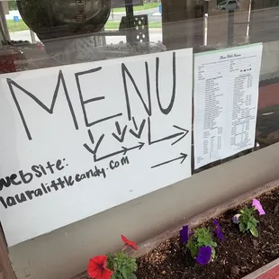 a menu sign in a window