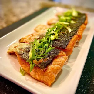 a plate of salmon and vegetables