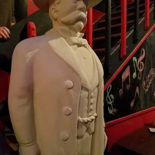 a statue of a man in a top hat