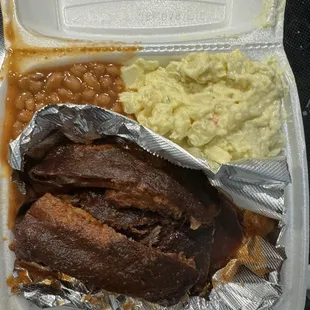 Rib plate with potato salad and baked beans. You get a side of white bread or cornbread. The sauce can also be served on the side