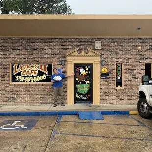 a man standing in front of a restaurant
