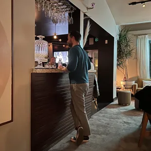 a man standing in front of a bar