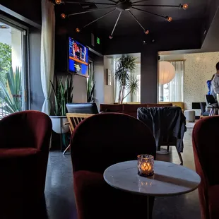 Cute loungey tables. Balcony door to the left with outdoor tables