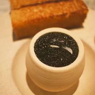 a bowl of cavia and toast on a plate