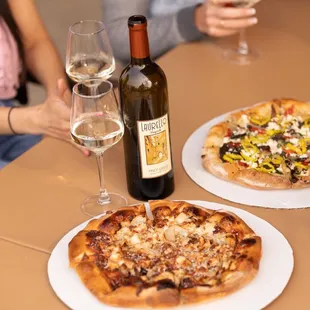 two pizzas and two glasses of wine