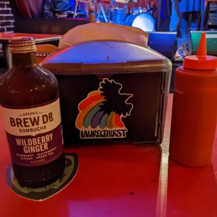 Kombucha, napkins, and ketchup, all brought out after ordering at the bar