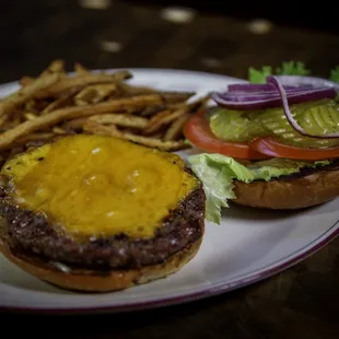 All American Cheese Burger is a 1/2 lb beef burger, topped with American cheese, tomato, lettuce, pickles, onions, mayo and brown mustard