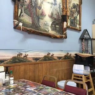 a table with a painting on the wall