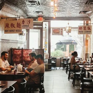 people sitting at tables in a restaurant