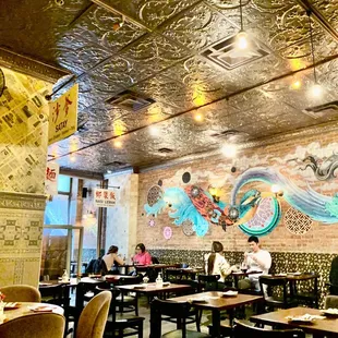 people sitting at tables in a restaurant