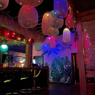 the interior of a tropical themed bar