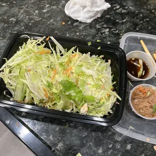 a salad and dipping sauces