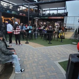 a man sitting on a bench in front of a fountain