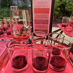 Member tasting under the red umbrellas