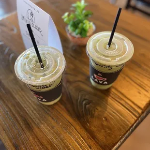 two cups of coffee on a wooden table