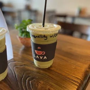 two cups of iced coffee on a wooden table