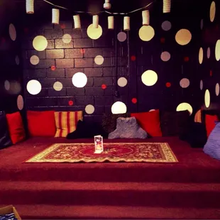 a bed with red and white pillows