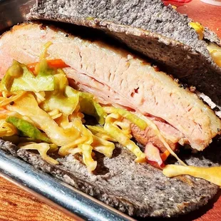 a meat sandwich with coleslaw