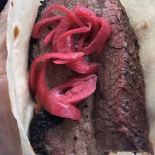 1/4 lb moist brisket with pickled red onions and a tortilla. Dec. &apos;23.