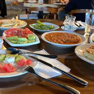 Full course breakfast. Eggs, cucumbers, tomatoes, olives, assorted breads and cheeses, fries, olives and much much more!