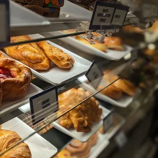 a variety of pastries on display in a bakery