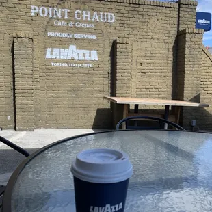 a cup of coffee sitting on a table