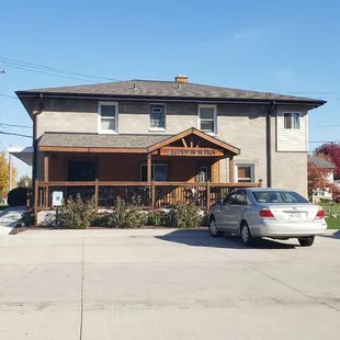 two cars parked in front of a house