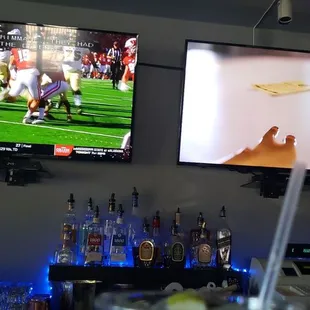 a football game being played on televisions