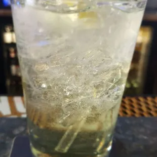 a glass of lemonade on a coaster