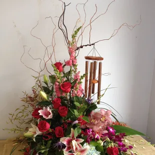 For a floral gift that makes a statement, combine flowers with a keepsake item like our beautiful chimes.