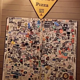a large pizza covered in stickers