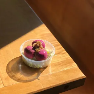 a bowl of ice cream and a drink on a table