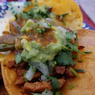 a plate of tacos with guacamole