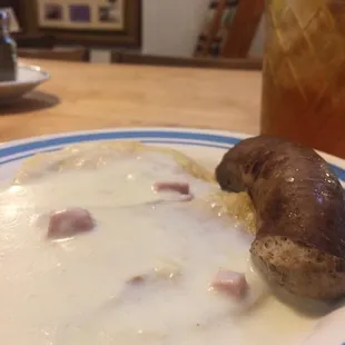 Verenika with ham gravy and a link of German sausage.