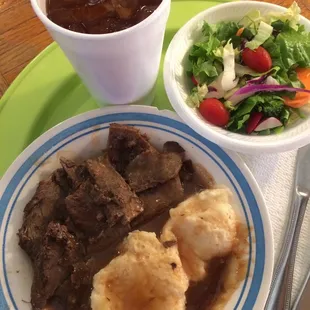 Open roast beef sandwich with homemade brown gravy made from the dripping of the roast and real mashed potatoes.