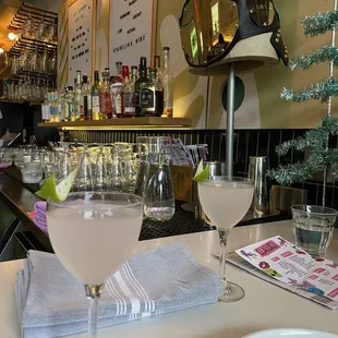 a martini and two glasses on a bar