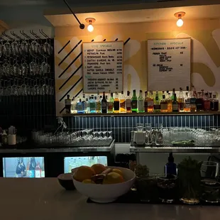 a bar with a bowl of fruit on the counter