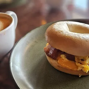 Yummy, perfectly toasted bagel with eggs, bacon and cheese.