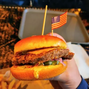 Cheeseburger with Impossible patty, complete with American flag, &quot;cuz you&apos;re in America!&quot;